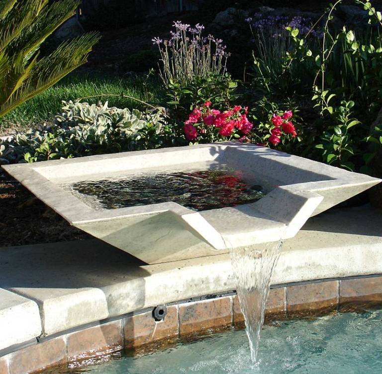 Attach an elegant pool fountain to the side of your pool to bring the 